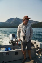 Jeff Perin looks out from moving boat while fishing