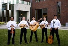 Jason stands in the center of his student-run mariachi group.