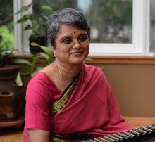 Sreevidhya Chandramouli sitting in front of her instrument. 