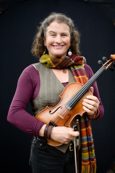 Woman holding a fiddle.