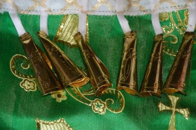 Bells worn during jingle dancing, set against a green and gold background