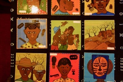 Four square art pieces depicting Malian stories and culture.