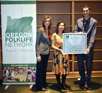Azar Salehi receiving an award from the Oregon Folklife Network