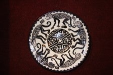 A traditional black and white patterned plate with animal imagery.