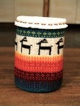 A blue, red, orange, yellow, white, and green woven basket featuring minimalist animal imagery.